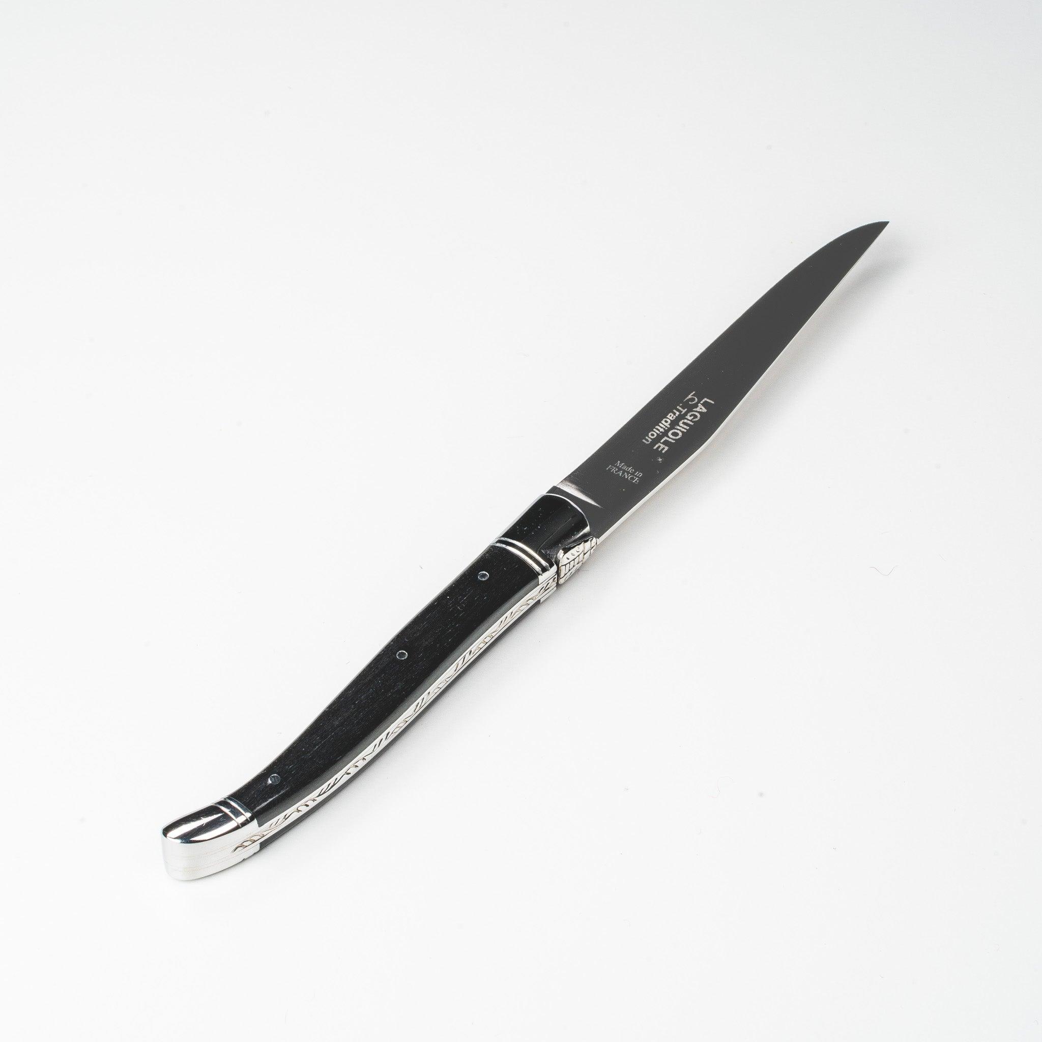 Laguiole Tradition steakkniv med håndtag i mørkt ibenholt og to blanke stålkraver